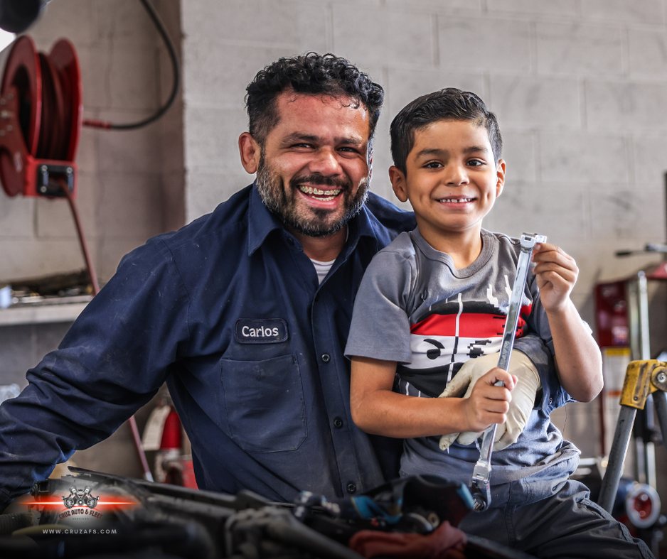 Carlos of Cruz Auto and Fleet with his son in the workshop