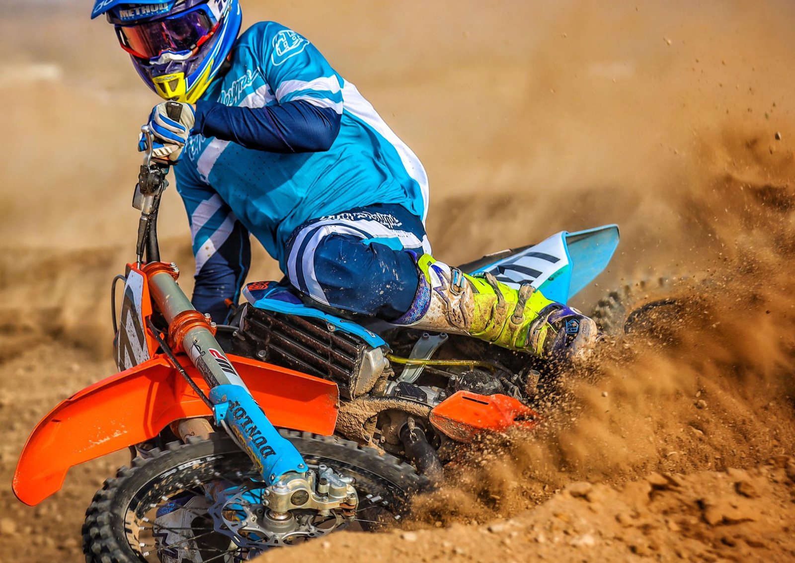 A rider laying the bike into a sand berm