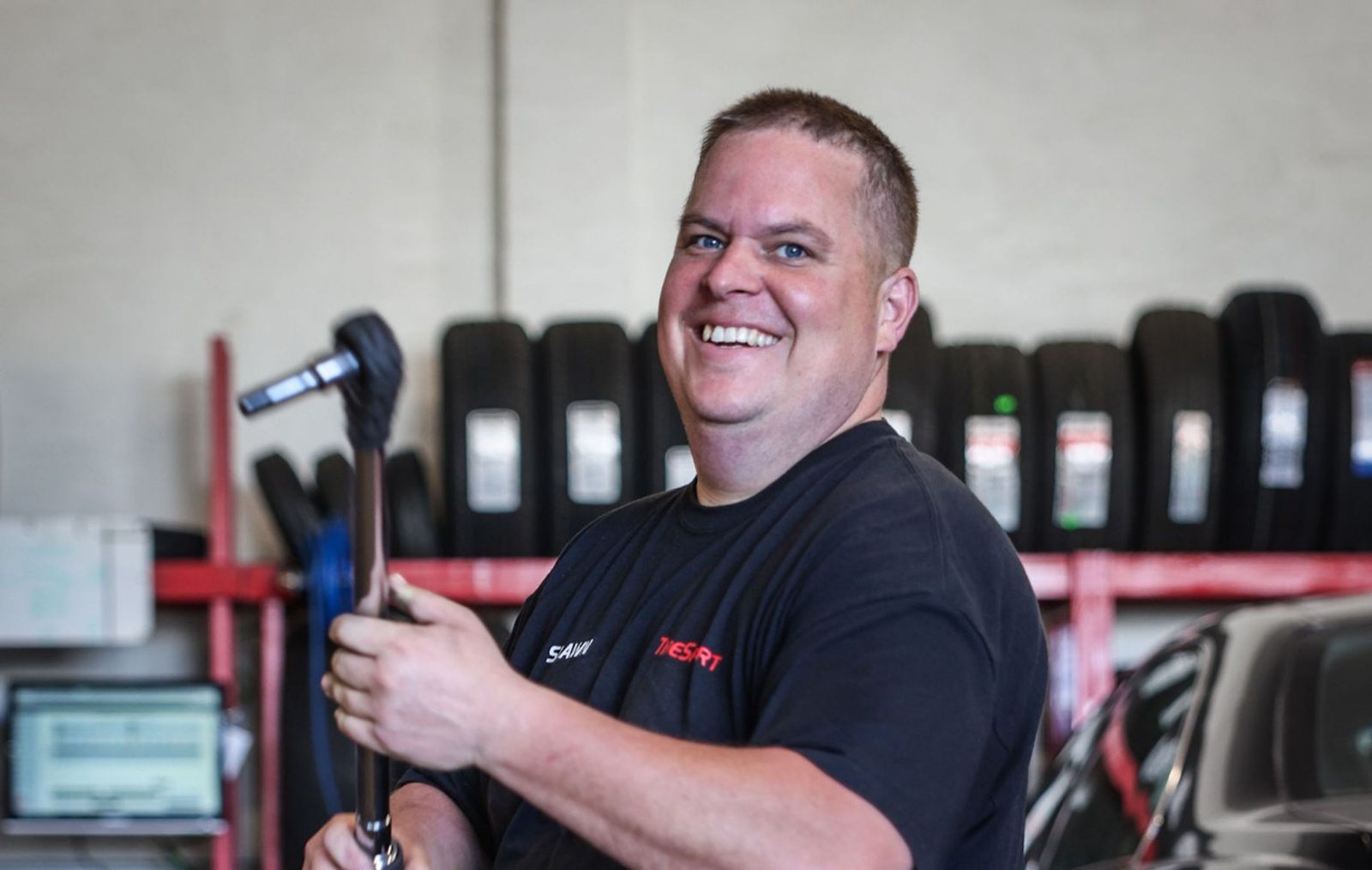 A technician at work in a tyre bay